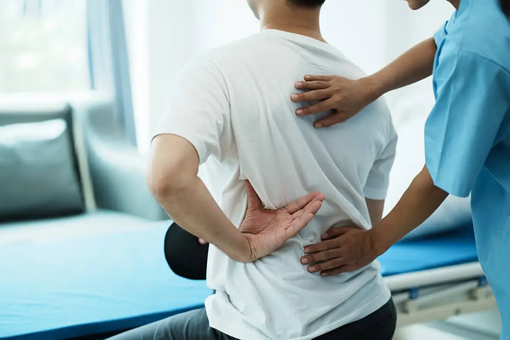 Shoulder blade pain: Causes, symptoms and treatments doctor consulting with patient back problems physi 2023 05 22 23 40 07 utc shoulder blade pain: causes, symptoms and treatments back pain